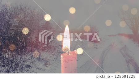Image of candles over winter road landscape 128691229