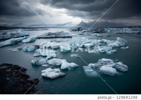 Ice floes floating in the ocean are the remnants of a melting glacier against the background of dark thunderclouds 128691298