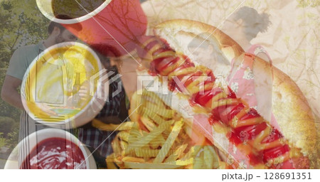 Image of diverse people making barbecue over hot dogs 128691351