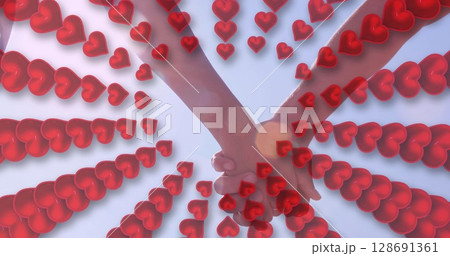 Image of hearts over hands of caucasian couple 128691361