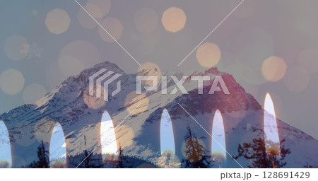 Image of candles over winter mountain landscape 128691429