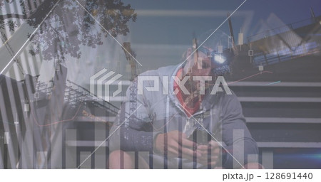 Image of financial data and graphs over caucasian man using smartphone Image of financial data and graphs over caucasian man using smartphone 128691440