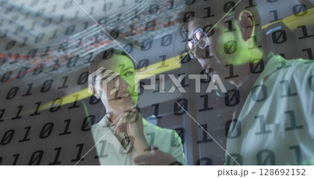 Image of data processing over diverse workers in server room 128692152