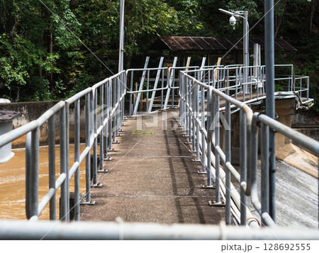 A concrete walkway across a dam in northern Thailand, which are constructions for monitoring concrete dams and water flow. 128692555