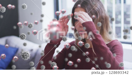 Image of virus cells over caucasian woman sneezing 128693342