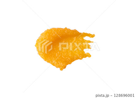 A sample of a orange body scrub with particles on a white background. A sample of a orange body scrub with particles on a white background. 128696001
