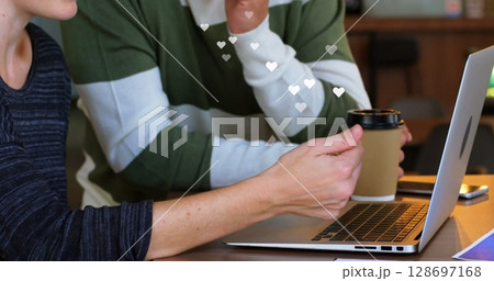 Image of media icon over caucasian businesswoman using laptop 128697168