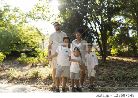Family enjoying summer holidays together posing in a park 128697549