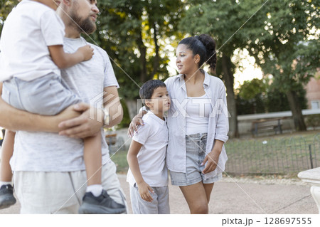Happy family walking and talking in a park 128697555