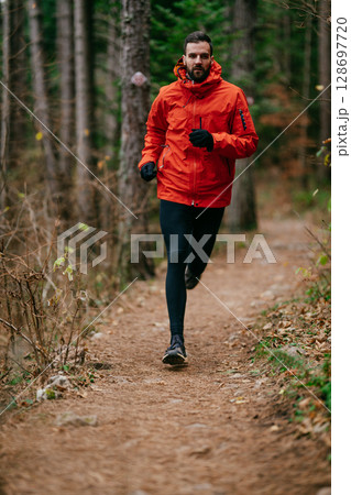 Jogger in Autumn Forest Trail Jogger in Autumn Forest Trail 128697720