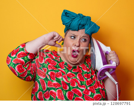 Colorful Woman Holding Iron and Shouting with Funny Expression Colorful Woman Holding Iron and Shouting with Funny Expression 128697791