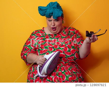 Colorful Woman Holding Iron and Shouting with Funny Expression Colorful Woman Holding Iron and Shouting with Funny Expression 128697821