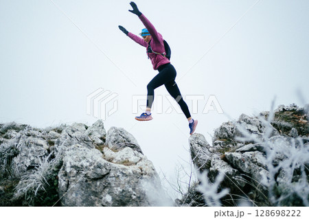 Trail Runner in Misty Mountain Landscape 128698222