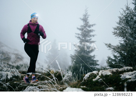 Trail Runner in Misty Mountain Landscape 128698223