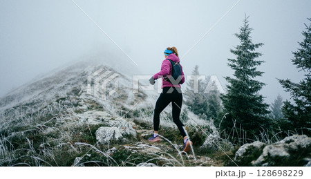 Trail Runner in Misty Mountain Landscape 128698229
