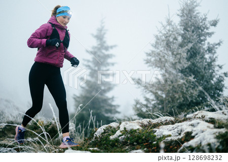 Trail Runner in Misty Mountain Landscape Trail Runner in Misty Mountain Landscape 128698232