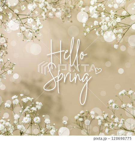 Spring card with Branches of blossoming white gypsophila flowers on beige background with bokeh effect and inscription Hello Spring. Spring time concept. Soft focus 128698775