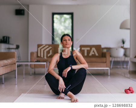 Young Beautiful Female Exercising, Stretching and Practising Yoga with Trainer via Video Call Conference in Bright Sunny House. Healthy Lifestyle, Wellbeing and Mindfulness Concept 128698832