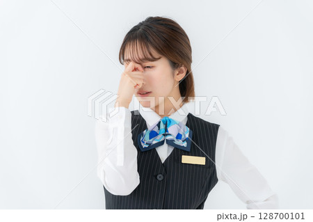 制服の若い女性　ビジネス　眼精疲労 128700101