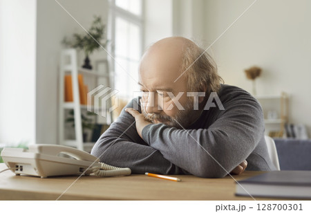 Ordinary Nervous Senior Man Waiting For Phone Call Ordinary Nervous Senior Man Waiting For Phone Call 128700301