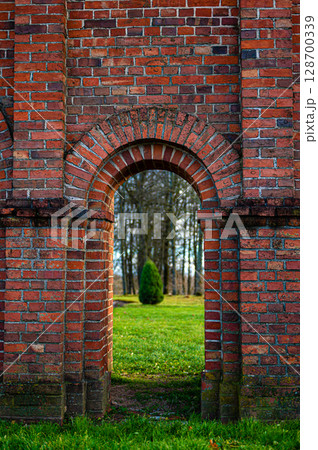 Old Catholic Church red brick gates in city Akniste, Latvia. Closeup Old Catholic Church red brick gates in city Akniste, Latvia. Closeup 128700339