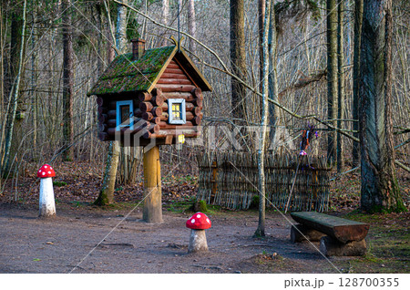 A hut on chicken legs stands in a fairy-tale, magical forest 128700355