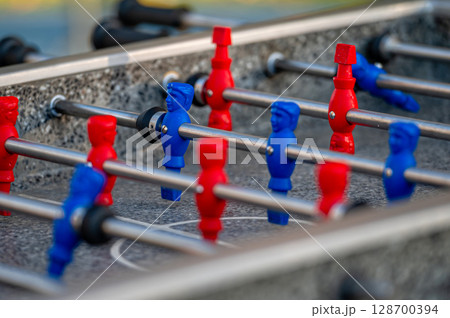 outdoor football table to play football with red and blue players, close up 128700394