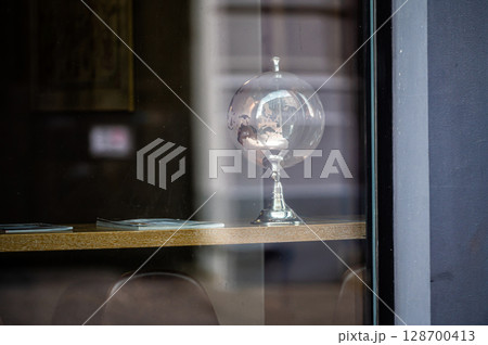 glass globe on table, view through window with street reflections, copy space glass globe on table, view through window with street reflections, copy space 128700413
