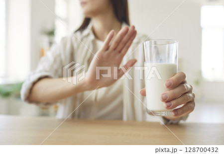Woman Refusing Milk Glass Due To Lactose Intolerance Woman Refusing Milk Glass Due To Lactose Intolerance 128700432