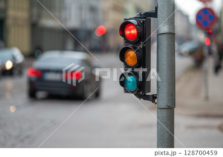 traffic light on the street junction with beautiful bokeh, city with cars in the background traffic light on the street junction with beautiful bokeh, city with cars in the background 128700459