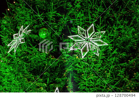 Christmas outdoor background with fir tree branches and Lights blurred bokeh. 128700494