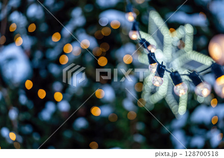 garland of light bulbs on defocused festive lights background, shallow depth of field, copy space garland of light bulbs on defocused festive lights background, shallow depth of field, copy space 128700518