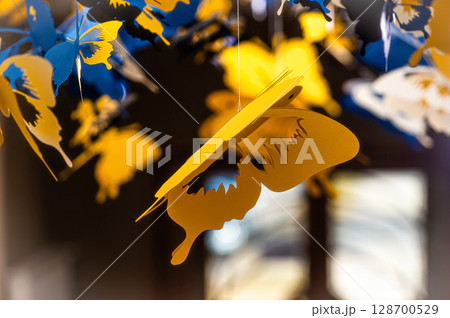 ceiling decorated with decorative colored paper butterflies, selective focus, blurred background ceiling decorated with decorative colored paper butterflies, selective focus, blurred background 128700529
