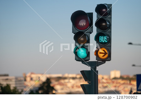 Traffic lights displaying signals for vehicles and buses in an urban area during daytime Traffic lights displaying signals for vehicles and buses in an urban area during daytime 128700902