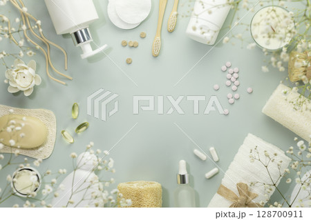 Eco friendly spa relax composition with beauty products, serums, soap, accessories and supplements on blue background. Wellness and skin care treatment. Concept of me time and self care. Copy space 128700911