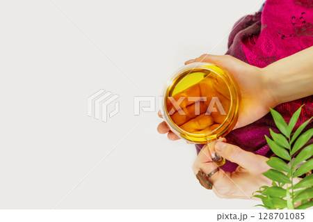 Woman relaxing and meditation with cup of healing herbal tea. Heart opening medicine. The concept of natural tea, maintenance of immunity, mental health and slow life. Flat lay, close up, copy space Woman relaxing and meditation with cup of healing herbal tea. Heart opening medicine. The concept of natural tea, maintenance of immunity, mental health and slow life. Flat lay, close up, copy space 128701085