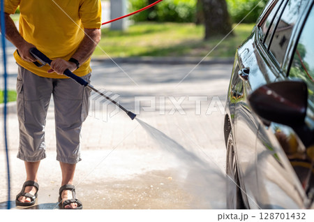Manual wash for perfect clean car. Cleaning car using high pressure water. 128701432