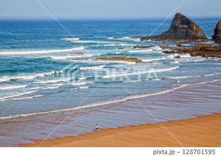 Surfer on empty beach in Alentejo Portugal Surfer on empty beach in Alentejo Portugal 128701595