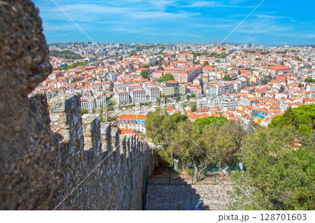 Old square with monument and trees in Lisbon 128701603