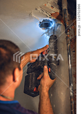 Mechanical man hand working fix electric drill motor roter fix repair shop 128702866