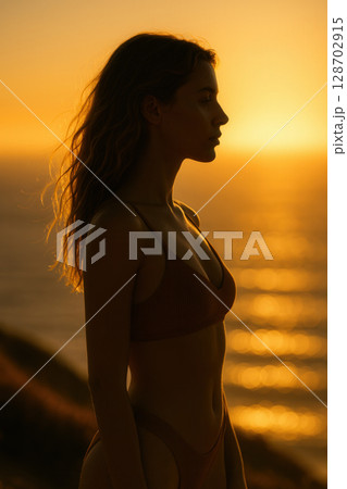Solitary Silhouette Reflecting at Sunrise over Sparkling Ocean Horizon in Meditative Serenity 128702915