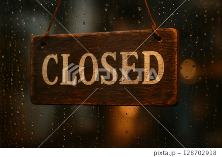 Vintage Wooden Closed Sign Hanging on Weathered Door Indicating Temporary Business Shutdown 128702918