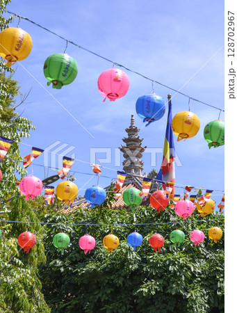 Long Son Pagoda in Nha Trang, Vietnam, decorated with Buddhist paper lanterns and flags 128702967