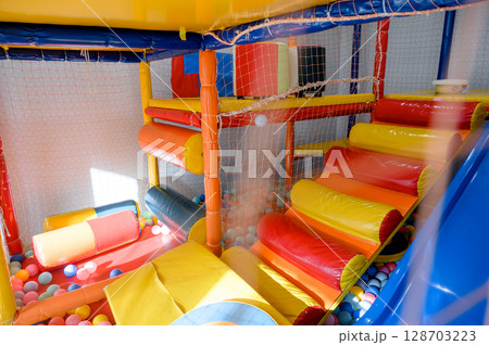 Play area for children. Slide and ball pit in the children's play center. Play area for children. Slide and ball pit in the children's play center. 128703223