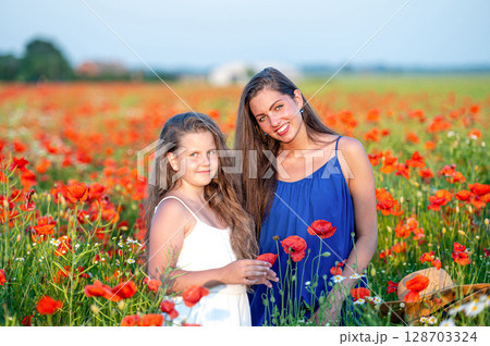 elegant young woman with child girl in poppy field, happy family having fun in nature, summer time elegant young woman with child girl in poppy field, happy family having fun in nature, summer time 128703324