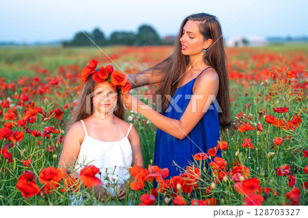 elegant young woman with child girl in poppy field, happy family having fun in nature, summer time elegant young woman with child girl in poppy field, happy family having fun in nature, summer time 128703327