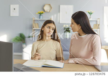 Sad Daughter And Mother Doing Homework And Having Conflict At Home 128703476