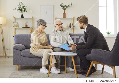 Old couple having negotiations with advisor or real estate agent 128703547
