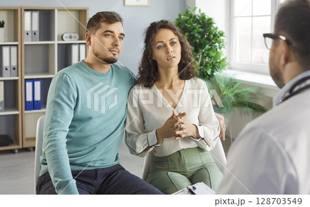 Couple visitng doctor, consulting couple at clinic, explaining medical records, giving information 128703549
