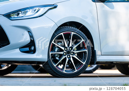 sports car wheels, low profile tires on aluminum rims, closeup 128704055